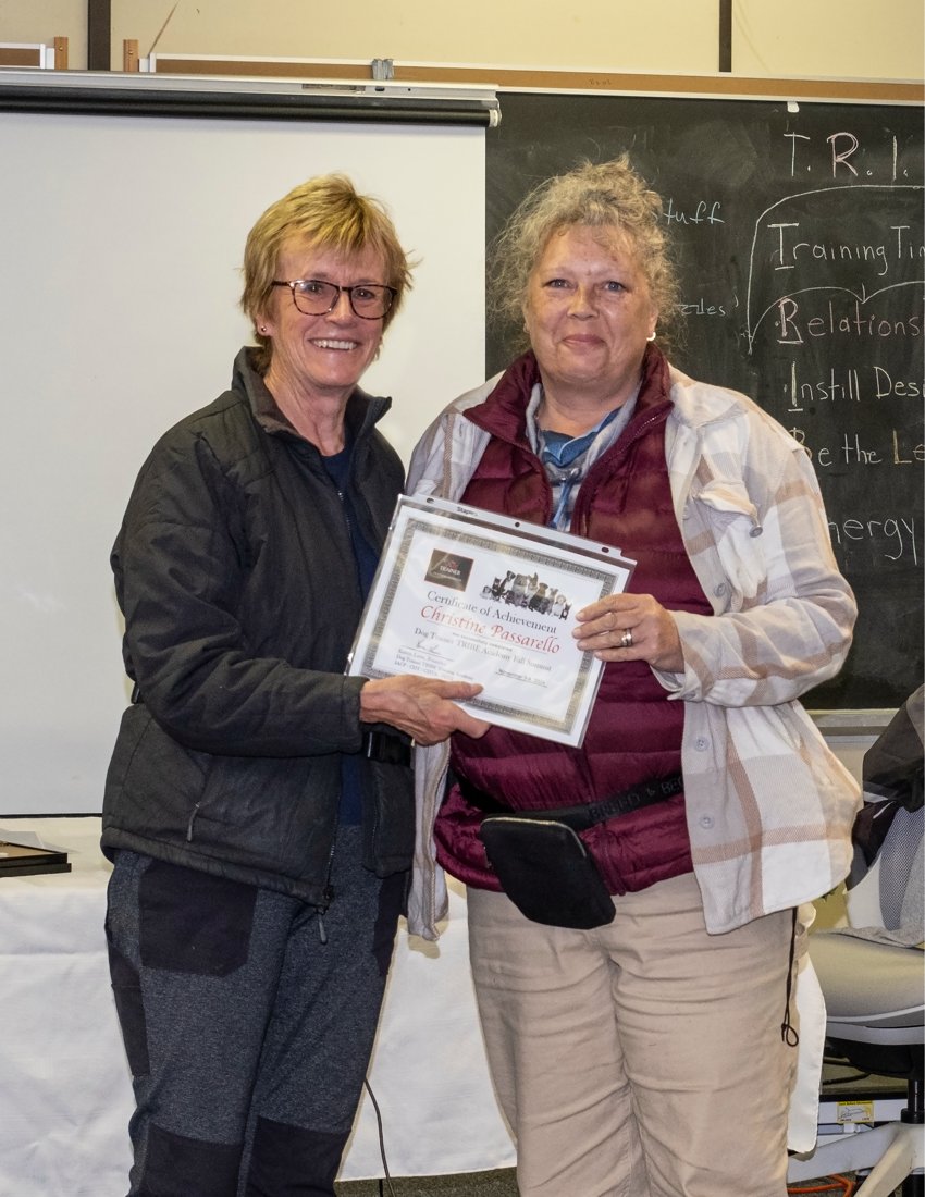 Christine P. receiving her T.R.I.B.E. Academy certificate from Karen Laws